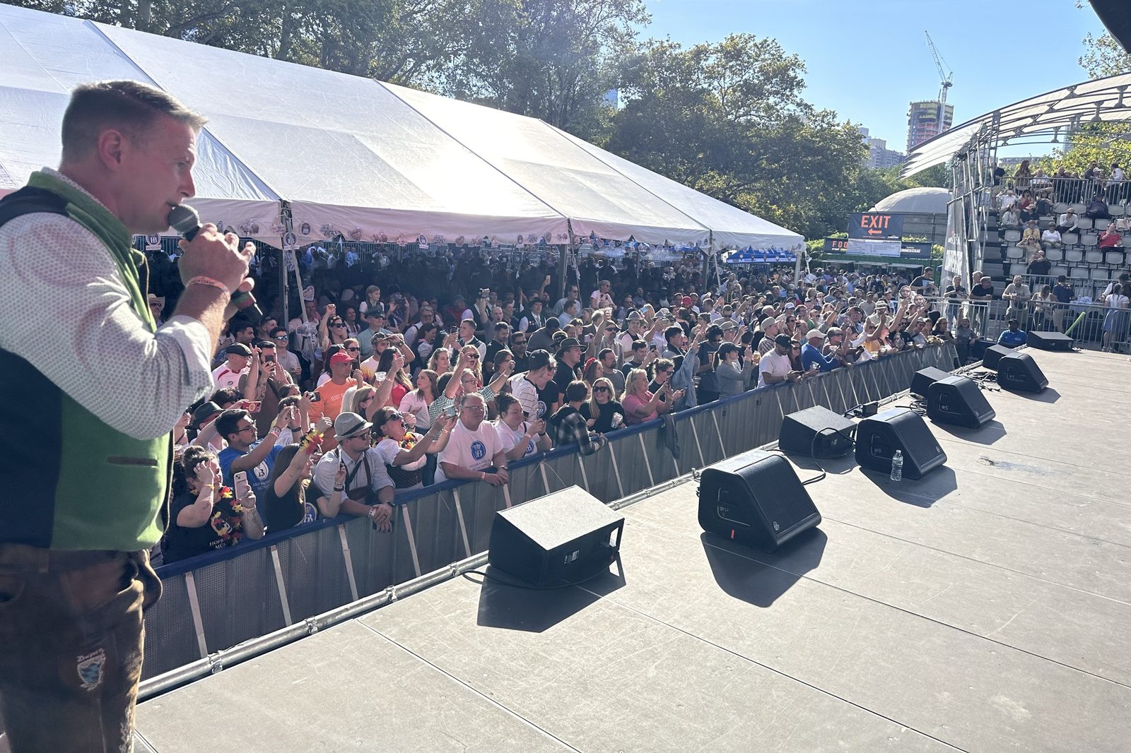 Jason Hurta on the mic in front of a packed Oktoberfest crowd in Central Park